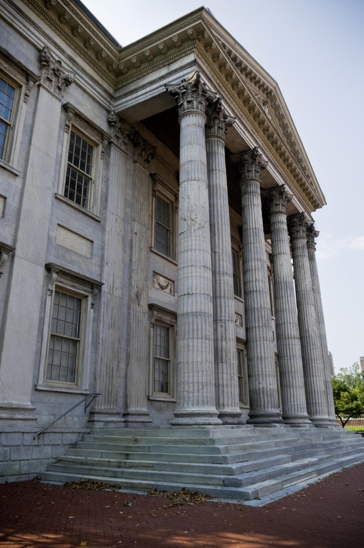 Banking Business. The facade of a bank building of Roman architecture. The entrance is a gallery under a high cornice held by six Corinthian columns.